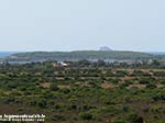 Porto Pino - 2009, col teleobiettivo dalla strada per Teulada: stagni, promontorio di Porto Pineddu e isola del Toro all'orizzonte (in realt&agrave; lontana 20 Km dalla riva)